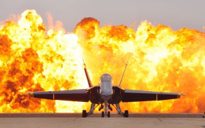 air show pyrotechnics, military jet, f-18, hornet, blue angel, flightline, detonation, dramatic effect, plane, airplane, aircraft, entertainment, ground, flames, fire